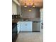 Bright kitchen featuring updated appliances, decorative lighting, and a view to the dining area at 8320 Sw 108Th Place Rd, Ocala, FL 34481