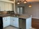 Well-equipped kitchen with a stainless steel dishwasher, updated lighting, and a breakfast bar at 8320 Sw 108Th Place Rd, Ocala, FL 34481