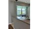 Kitchen view showcasing a window with sheer curtains, sink, and neutral countertops at 8320 Sw 108Th Place Rd, Ocala, FL 34481