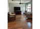Cozy living room with hardwood floors, a ceiling fan, and comfortable seating at 8320 Sw 108Th Place Rd, Ocala, FL 34481