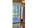 A sliding glass door with a dog door leads to the screened patio at 8320 Sw 108Th Place Rd, Ocala, FL 34481
