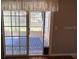 A sliding glass door with a dog door leads to the screened patio at 8320 Sw 108Th Place Rd, Ocala, FL 34481