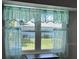 Window view of backyard featuring decorative sheer curtains providing natural light at 8320 Sw 108Th Place Rd, Ocala, FL 34481