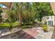 The backyard includes a brick patio with a table surrounded by mature landscaping at 8400 Sw 90Th St # C, Ocala, FL 34481