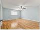 Bedroom features ceiling fan, new wood floors, and large windows at 8400 Sw 90Th St # C, Ocala, FL 34481