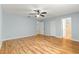 Spacious bedroom featuring ceiling fan, beautiful floors, and ensuite bathroom at 8400 Sw 90Th St # C, Ocala, FL 34481