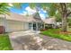 A well-maintained single-story home with a spacious driveway and attached garage, set in a tree-lined neighborhood at 8400 Sw 90Th St # C, Ocala, FL 34481