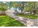 A neighborhood streetscape featuring well-kept homes with garages and landscaped yards, shaded by mature trees at 8400 Sw 90Th St # C, Ocala, FL 34481
