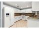 Well-lit kitchen with white cabinets, granite countertops, and stainless steel appliances offers ample space at 8400 Sw 90Th St # C, Ocala, FL 34481