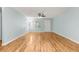 Bright living room with hardwood flooring, ceiling fan, and large window, offering comfortable living space at 8400 Sw 90Th St # C, Ocala, FL 34481
