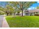 A serene street view showcases lovely homes with beautiful lawns, lush trees, and inviting curb appeal at 8400 Sw 90Th St # C, Ocala, FL 34481
