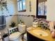 Bathroom with decorative tile accent wall, single sink vanity, and toilet at 8547 Sw 106Th Pl, Ocala, FL 34481
