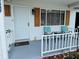 Close-up view of the well decorated front porch with comfortable seating and a 'welcome' doormat at 8547 Sw 106Th Pl, Ocala, FL 34481