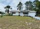 Charming single story home featuring a manicured front yard with mature trees and a driveway at 8547 Sw 106Th Pl, Ocala, FL 34481