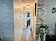 Inviting hallway with brick accents and a view of an office, creating a welcoming entryway at 8547 Sw 106Th Pl, Ocala, FL 34481