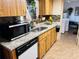 Functional kitchen with granite countertops, black appliances, and ample cabinet space for storage at 8547 Sw 106Th Pl, Ocala, FL 34481