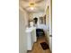 Practical laundry room with washer, dryer, and storage shelves, providing convenience at 8547 Sw 106Th Pl, Ocala, FL 34481