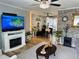 Open-concept living room showcasing hardwood floors, stone accent walls, and comfortable seating at 8547 Sw 106Th Pl, Ocala, FL 34481