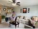 Spacious living room with hardwood floors, stone accent wall, and comfortable seating at 8547 Sw 106Th Pl, Ocala, FL 34481