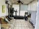 Bright sunroom with white walls, comfortable seating, a ceiling fan, and exercise equipment at 8547 Sw 106Th Pl, Ocala, FL 34481