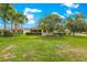 Lush green backyard with view of home and palm trees in background at 8566 Sw 83Rd Loop, Ocala, FL 34481