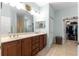 Bright bathroom boasts a double vanity, linen closet and walk-in closet for ample storage at 8566 Sw 83Rd Loop, Ocala, FL 34481