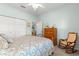 Comfortable bedroom featuring a rocking chair, a dresser and carpeted floors at 8566 Sw 83Rd Loop, Ocala, FL 34481