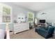 Bright bedroom with neutral walls, with large windows, white furniture and carpeted floors at 8566 Sw 83Rd Loop, Ocala, FL 34481