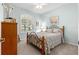 Cozy bedroom with a patterned bedspread, window with blinds and a dresser at 8566 Sw 83Rd Loop, Ocala, FL 34481