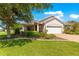 Beautiful single-story home with manicured lawn and landscaping, complemented by a paver driveway at 8566 Sw 83Rd Loop, Ocala, FL 34481