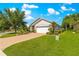 Well-maintained lawn and landscaping highlight this single-story home, with a paver driveway and mature trees at 8566 Sw 83Rd Loop, Ocala, FL 34481