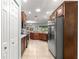 Bright kitchen with tiled floors, stainless steel appliances, and wood cabinets offering plenty of storage space at 8566 Sw 83Rd Loop, Ocala, FL 34481