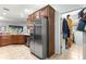 Well-lit kitchen featuring stainless steel refrigerator, ample counter space, and convenient access to storage areas at 8566 Sw 83Rd Loop, Ocala, FL 34481