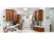 Well-lit kitchen featuring stainless steel appliances, wood cabinets and light countertops at 8566 Sw 83Rd Loop, Ocala, FL 34481