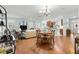 Open-concept living area with hardwood floors, neutral decor, and seamless transition to the kitchen at 8566 Sw 83Rd Loop, Ocala, FL 34481