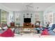 Bright living room with a ceiling fan, windows, and an entertainment center perfect for relaxation and enjoyment at 8566 Sw 83Rd Loop, Ocala, FL 34481