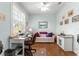 Bright home office with a window, hardwood floors, and a comfortable sitting area at 8566 Sw 83Rd Loop, Ocala, FL 34481