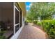 Charming side patio with brick pavers, offering serene outdoor relaxation space at 8566 Sw 83Rd Loop, Ocala, FL 34481
