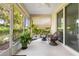 Relaxing screened patio with ceiling fan and mature plants at 8566 Sw 83Rd Loop, Ocala, FL 34481