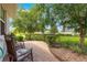 Inviting brick paver patio with rocking chairs, perfect for enjoying the serene outdoor space at 8566 Sw 83Rd Loop, Ocala, FL 34481