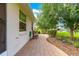 Inviting side patio with brick pavers and charming rocking chairs at 8566 Sw 83Rd Loop, Ocala, FL 34481