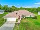 Aerial view of a ranch style home featuring a pristine lawn, a two car garage, and manicured landscaping at 10151 Sw 41St Ter, Ocala, FL 34476