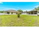 Expansive backyard featuring green grass, the home's back exterior, and a screened-in porch at 10151 Sw 41St Ter, Ocala, FL 34476