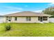 A wide shot of the backyard with an ample yard, an outdoor shower and a screened in porch for outdoor enjoyment at 10151 Sw 41St Ter, Ocala, FL 34476