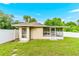 Backyard with lush green grass, perimeter fence, and enclosed lanai with a solid roof at 10151 Sw 41St Ter, Ocala, FL 34476