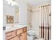 Well-lit bathroom featuring a shower-tub combo with a patterned curtain at 10151 Sw 41St Ter, Ocala, FL 34476