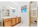 Bathroom with walk-in shower, double sink vanity, and decor at 10151 Sw 41St Ter, Ocala, FL 34476