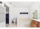 Bright bathroom featuring a toilet, bathtub, vanity, and dark wall art at 10151 Sw 41St Ter, Ocala, FL 34476