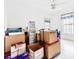 Bedroom filled with boxes and furniture, featuring a ceiling fan and natural light at 10151 Sw 41St Ter, Ocala, FL 34476