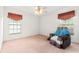 Empty bedroom with plush carpet, natural light, and a comfy chair at 10151 Sw 41St Ter, Ocala, FL 34476